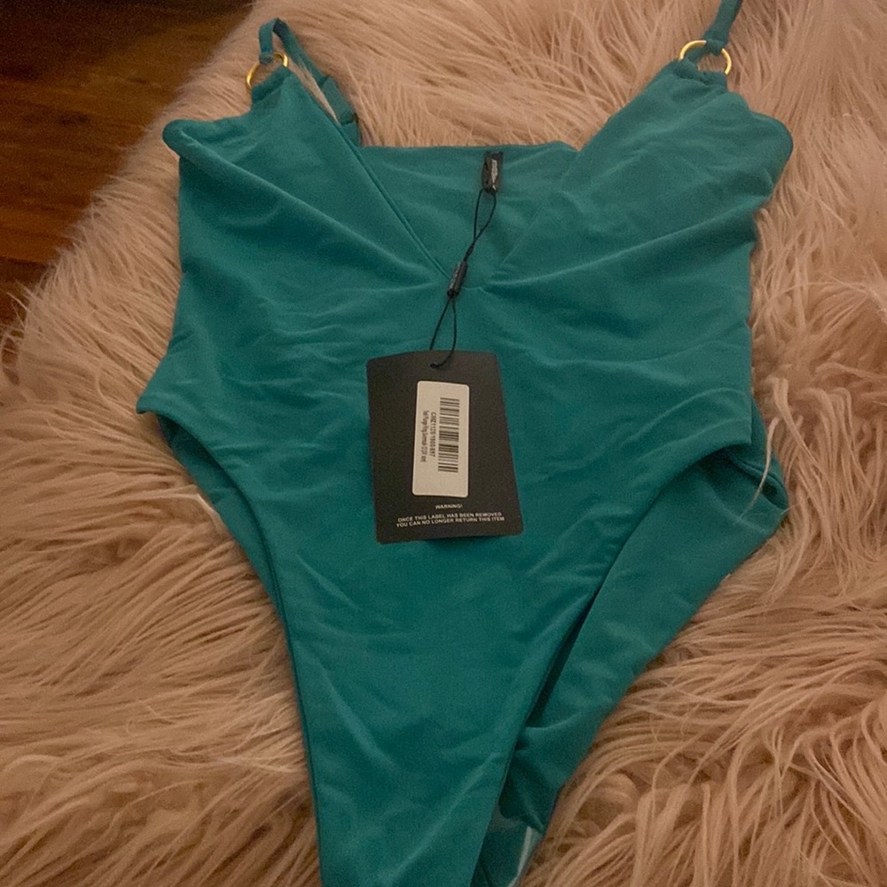 Beautiful deep v cut gold ring on shoulder one piece bathing suit…